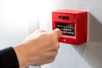 hand pressing fire alarm break glass emergency switch designed for safety and awareness in case of fire emergencies seven important safety steps